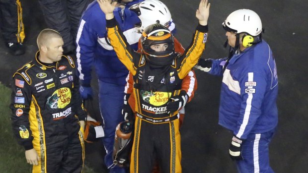 Dillon raises his arms to race fans to signify he was okay after the crash. 