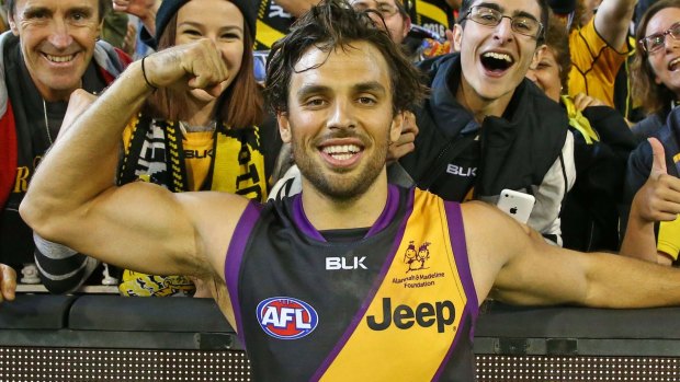 MELBOURNE, VICTORIA - MAY 14: Sam Lloyd of the Tigers celebrates with Tigers supporters in the crowd after kicking the match-winning goal after the final siren during the round eight AFL match between the Richmond Tigers and the Sydney Swans at the Melbourne Cricket Ground on May 14, 2016 in Melbourne, Australia. (Photo by Scott Barbour/AFL Media/Getty Images)