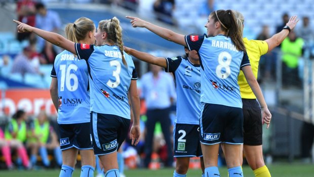 Protest: Sydney FC players object to a penalty ruling.