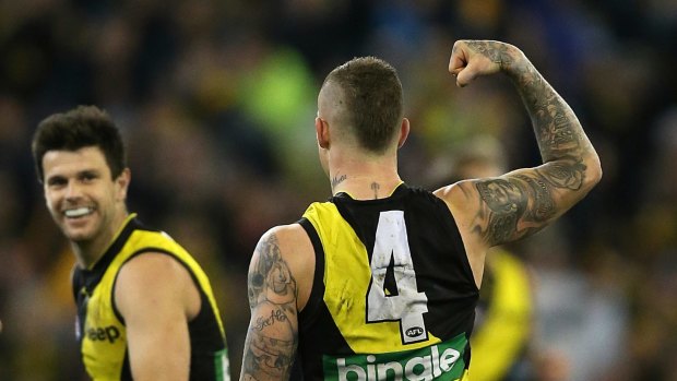 Dustin Martin celebrates in front of a massive crowd at the MCG.