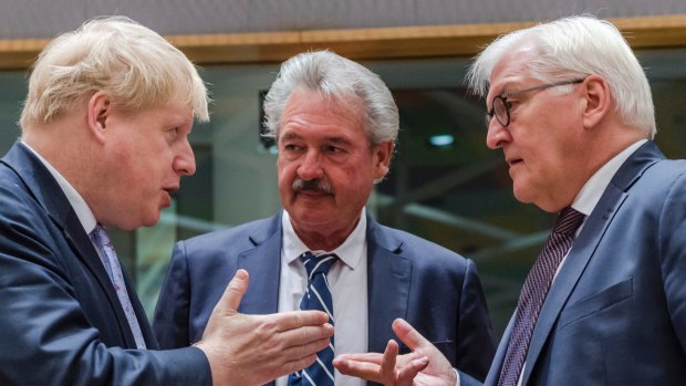 German Foreign Minister Frank-Walter Steinmeier, right, talks with British Foreign Secretary Boris Johnson, left, and Luxembourg's Foreign Minister Jean Asselborn in Brussels.
