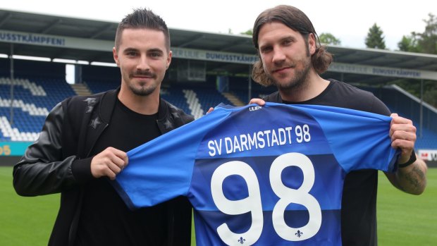 Fresh start: Jamie Maclaren shows off his new colours with coach Torsten Frings.