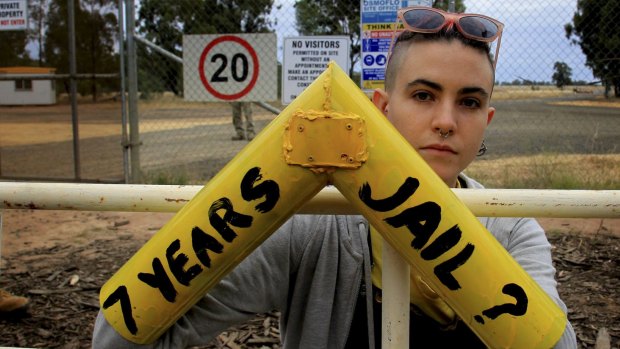A protester locks on to a gate that is part of Santos' Narrabri CSG project.