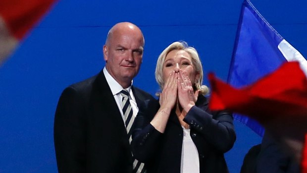 French far-right presidential candidate Marine Le Pen, flanked with her body guard Thierry Legier, blows kisses to supporters at the end of her meeting in Villepinte, outside Paris.
