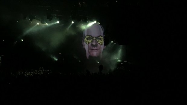 The 10,000-odd revellers at the Riverstage rave away under the giant visage of Fatboy Slim.