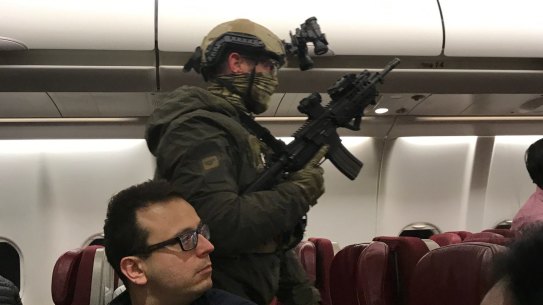 Heavily armed police boarded the plane after it returned to Melbourne.