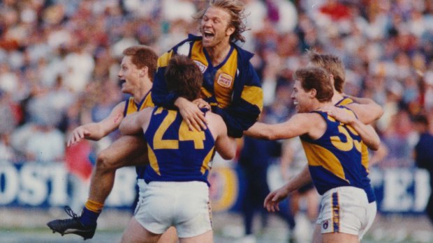 John Worsfold hugs old mates Guy McKenna and Chris Mainwaring after West Coast's first premiership in 1992.