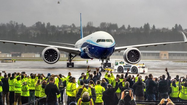 Boeing employees and family members cheer the 777X at Boeing Field in Seattle after it completed its maiden flight.