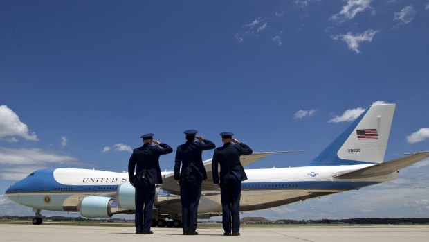Military personnel salute as Air Force One, with President Barack Obama and Democratic presidential candidate Hillary Clinton aboard, departs Joint Base Andrews, Maryland, in July.