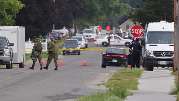 Police gather evidence outside of a house in Strathroy, Ontario, on Thursday, after Aaron Driver was killed in a confrontation with police.  