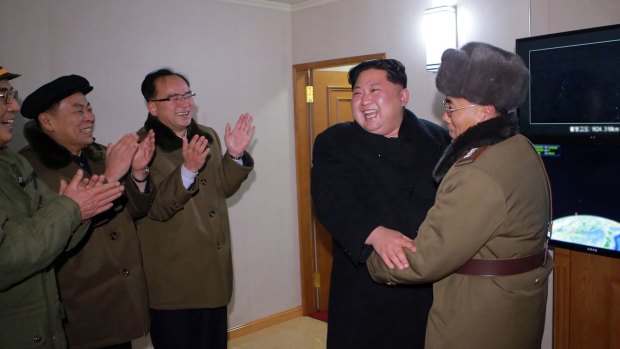 North Korean leader Kim Jong-un celebrates the launch of a missile on Wednesday.