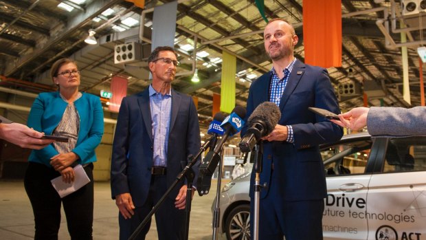 Chief Minister Andrew Barr, with Ken Kroeger of Seeing Machines, centre, and local industry advocate Kate Lundy, left, announcing a driverless car trial on Friday.