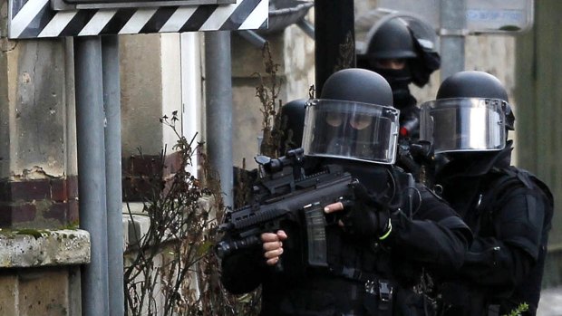 SWAT police officers on patrol in the village of Longpont, north-east of Paris, in search of the two heavily armed brothers suspected in the massacre at <i>Charlie Hebdo</i> magazine.