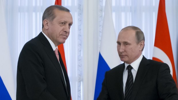 Russian President Vladimir Putin, right, and Turkish President Recep Tayyip Erdogan shake hands after talks outside St Petersburg in Russia.