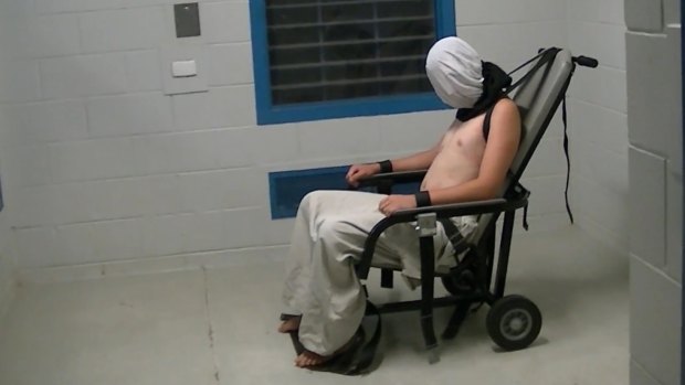 Dylan Voller is hooded and strapped to a restraining chair in the footage aired on Four Corners. 