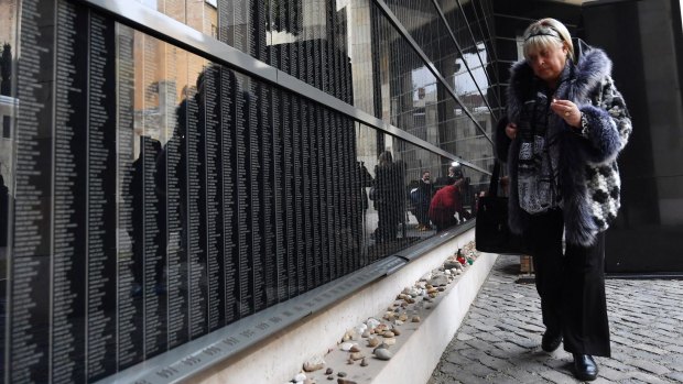 Holocaust survivor Katalin Sommer lights a candle at the Victims' Memorial Wall in the Holocaust Memorial Centre in Budapest, Hungary. This year is the 70th anniversary of the liberation of the Auschwitz concentration camp.