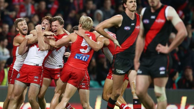 Gary Rohan celebrates with team mates after kicking a goal to win the match during the round 14 AFL match between the Sydney Swans and the Essendon Bombers.