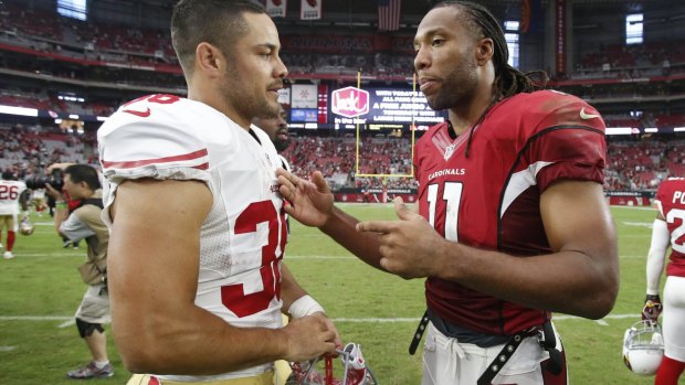 Getting some tips: Cardinals wide receiver Larry Fitzgerald talks with Jarryd Hayne after the game.