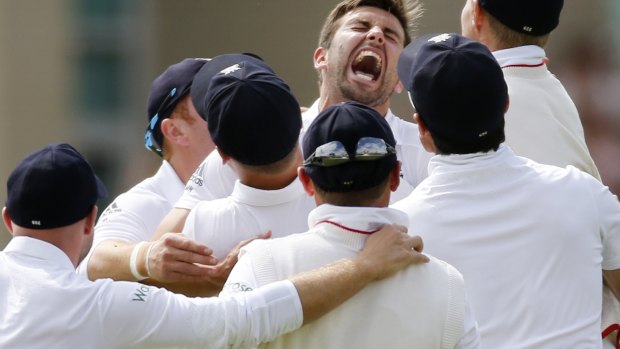 England's Mark Wood celebrates the wicket of Australia's Nathan Lyon with team mates.