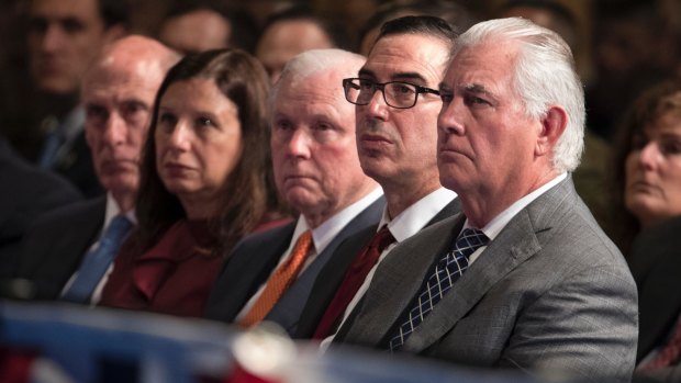 From right, Secretary of State Rex Tillerson, Treasury Secretary Steven Mnuchin, and Attorney-General Jeff Sessions listen to to Donald Trump as he speaks at Fort Myer.