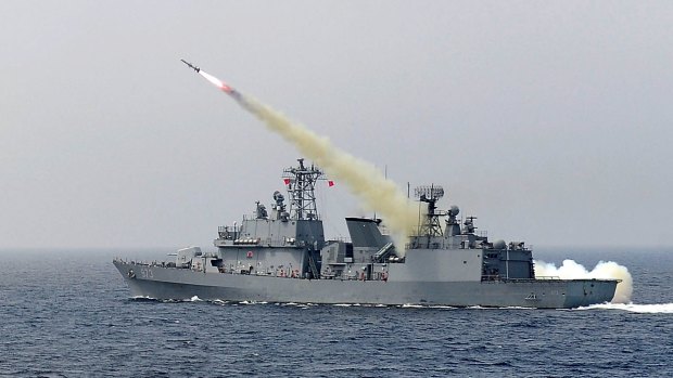 A South Korean navy ship fires a missile during a drill aimed to counter North Korea's intercontinental ballistic missile test on July 6 in the East Sea.