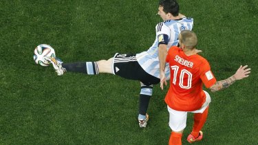 Argentina's Lionel Messi is challenged by Netherlands' Wesley Sneijder.