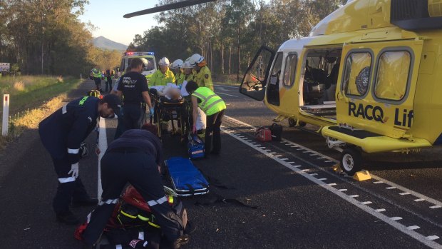 Patients are treated after a crash on the Bruce Highway south of Maryborough on Monday.