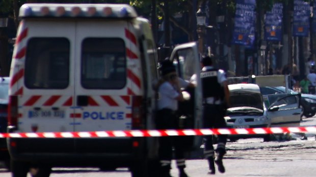 Police forces secure the area after a man rammed a police vehicle on the Champs Elysees in Paris, in June.