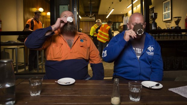 Construction workers Ron Horn and David Jones enjoy early morning coffee at Spriga Espresso Bar on King Street, Melbourne. 

