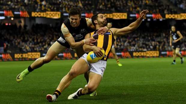 Collared: Marc Murphy stops Paul Puopolo, albeit illegally, on the way to Carlton’s first win over Hawthorn since 2005.