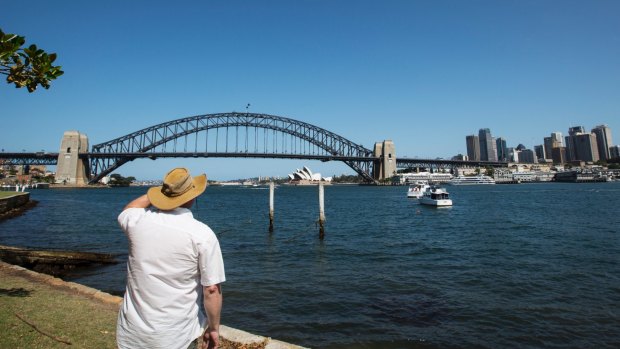 A tourist takes in the view from Blues Point Reserve.