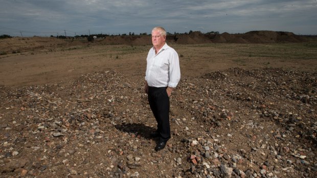 Sobering experience: Jim Guy  looks at the mounds of rubble on his Trugagnina property.