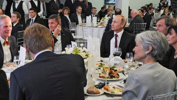 Michael Flynn (centre left) next to President Vladimir Putin at an event celebrating RT in Moscow. Jill Stein, 2016 US Greens candidate, is seen with her back to camera. 