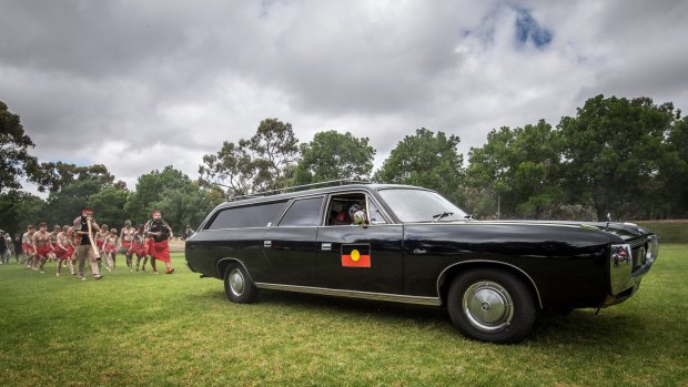 The children of the Tirkandi Inaburra dance group follow the hearse as it arrives in Hay.