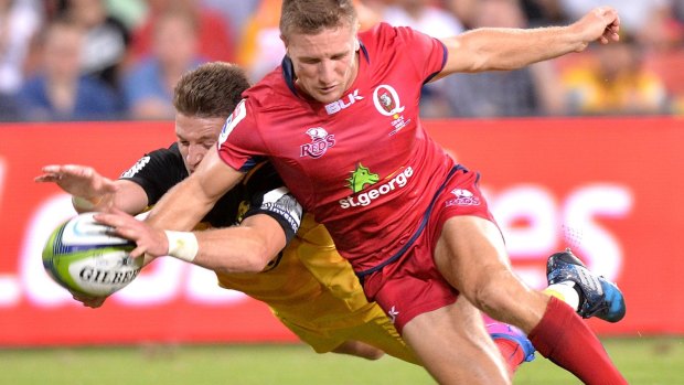 Momentum changes: Beauden Barrett of the Hurricanes and James Tuttle of the Reds challenge for the ball with the try disallowed.