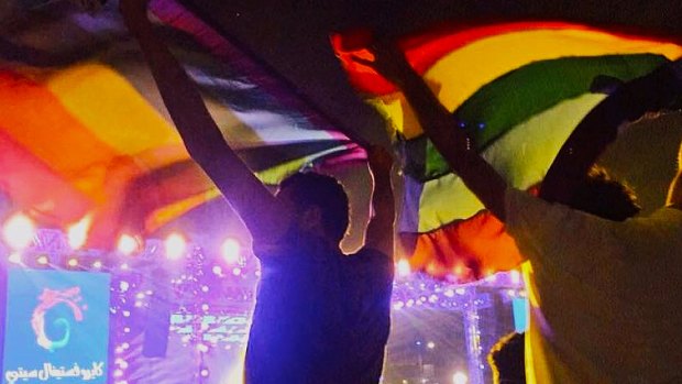 Image of two people holding up a rainbow flag at a concert in Cairo, Egypt Security officials said those arrested have been charged with "inciting immorality".