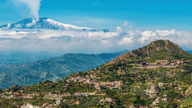 A smoking Mount Etna, as seen from the scenic mountain town of Taormina.