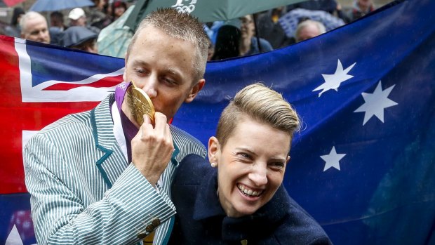 Gold finally: Jared Tallent with his wife Claire at the gold medal presentation ceremony in Melbourne for the 50km walk for the 2012 London Olympics. 