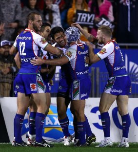 Warriors players celebrate during their nine-point win over Brisbane.