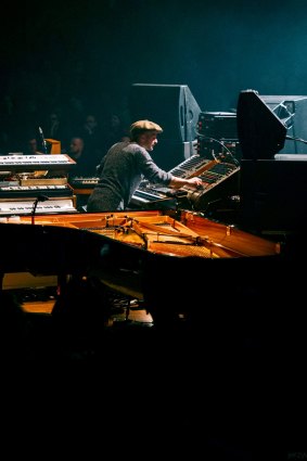 Nils Frahm on stage with his assortment of instruments.