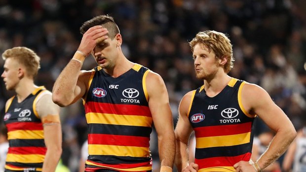 Taylor Walker (left) and Rory Sloane of the Crows look dejected after a loss during the 2017 AFL round 11 match between the Geelong Cats and the Adelaide Crows at Simonds Stadium on Friday. 