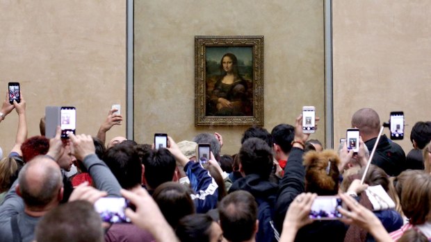 Most visitors tend to take photos of the famous painting, rather than just look at it. 