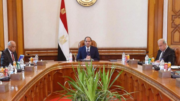 The shortage of sugar and other subsidised goods has focused anger on the economic management of Egyptian President Abdel-Fattah al-Sisi, centre, and his government.