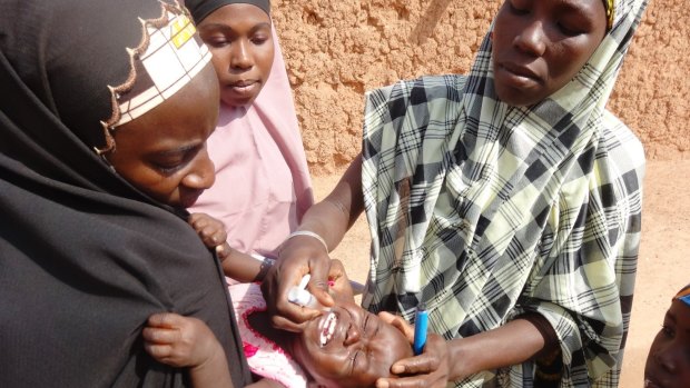 A polio vaccinator giving a child the vaccine in northern Nigeria in 2013.