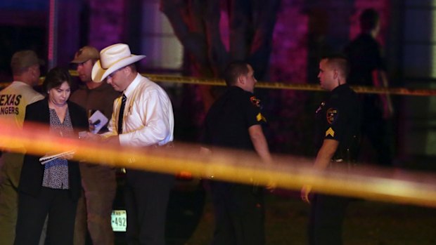 Law enforcement officers gather outside the scene of the shooting in Plano, Texas.