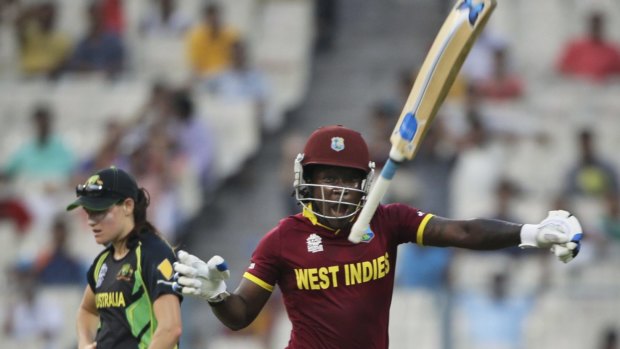 Deandra Dottin throws the bat skyward after the West Indies won the T20 World Cup.