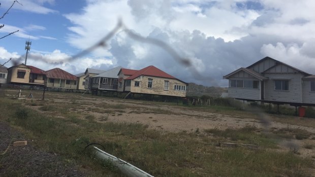 The road to Brisbane's proposed cruise ship terminal at Luggage Point is lined with abandoned cars and houses.