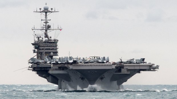 Aircraft carrier USS Harry S. Truman transits the Strait of Hormuz on Boxing Day. 