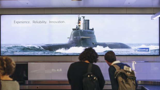 An advertising poster featuring a submarine at Canberra Airport.