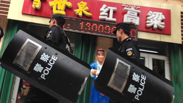 Chinese police patrol a street in Urumqi, the capital of Xinjiang region.